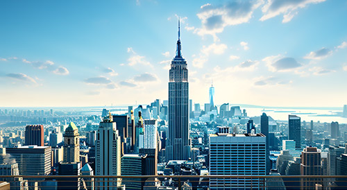 A panoramic view of New York City skyline featuring the Empire State Building under a clear blue sky, symbolizing urban growth, architecture, and economic vitality.