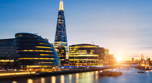 London cityscape at sunset featuring The Shard and modern riverside buildings, symbolizing urban innovation, business growth, and architectural excellence.