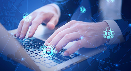 Hands typing on a laptop with floating Bitcoin icons and a digital world map overlay, symbolizing global cryptocurrency trading, blockchain connectivity, and online digital finance.