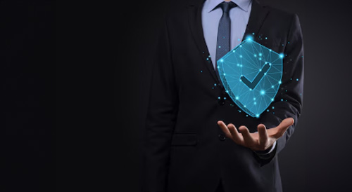 Businessman holding a glowing digital shield with a checkmark symbolizing safety, protection, and security.