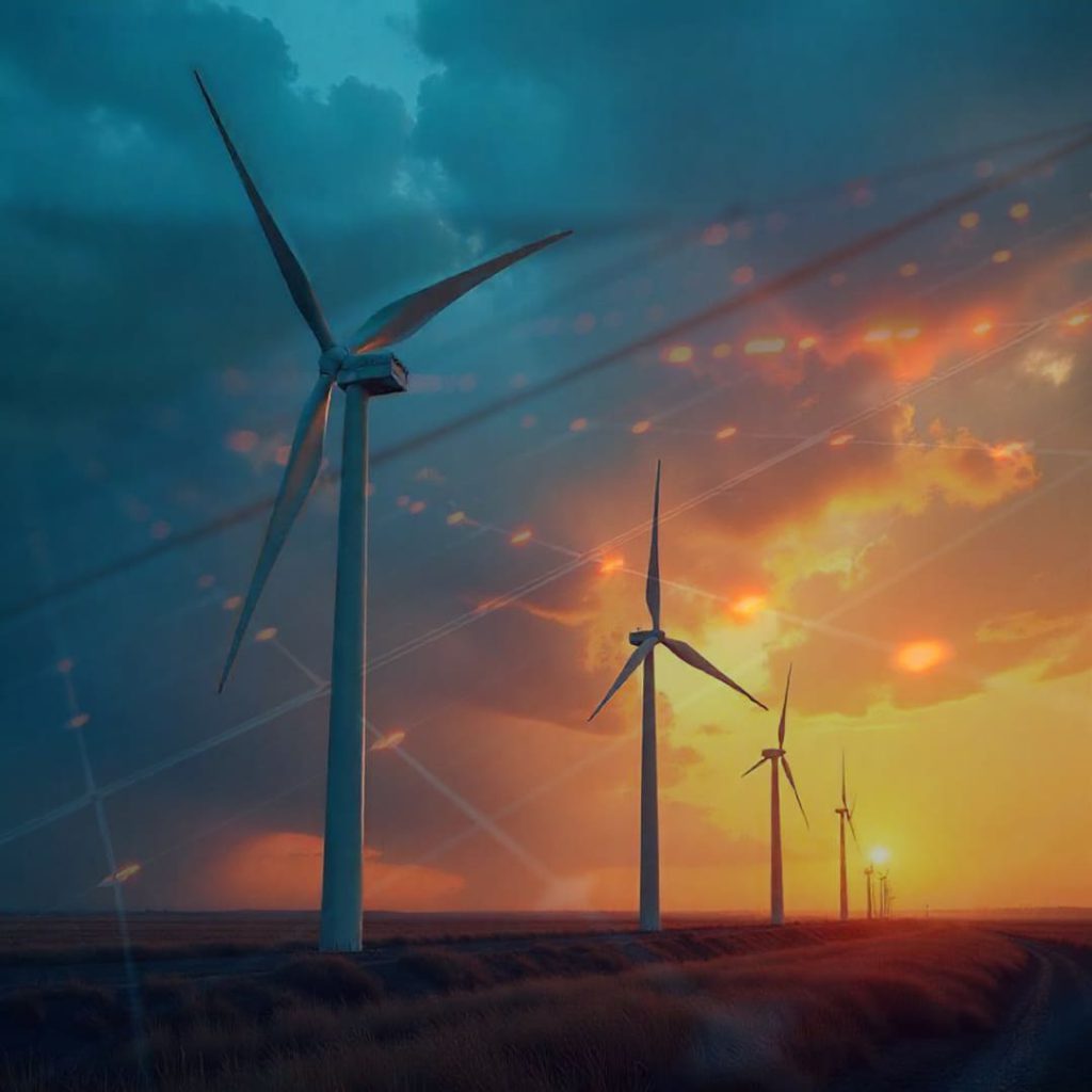 Wind turbines spinning under a dramatic sunset sky with digital energy lines overlay, symbolizing the future of clean technology and renewable energy innovation.