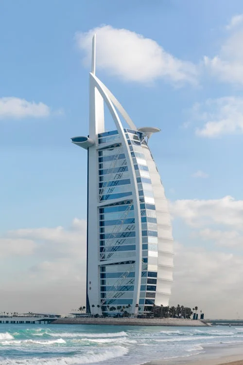 Iconic Burj Al Arab hotel standing on the Dubai coastline, symbolizing luxury, innovation, and the architectural excellence that defines the UAE’s global tourism and economic vision.