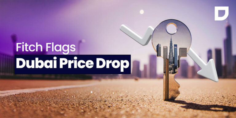 Key with Dubai skyline and downward arrows symbolizing real estate market decline, illustrating Fitch’s warning on falling property prices and investment risks in Dubai’s housing sector.