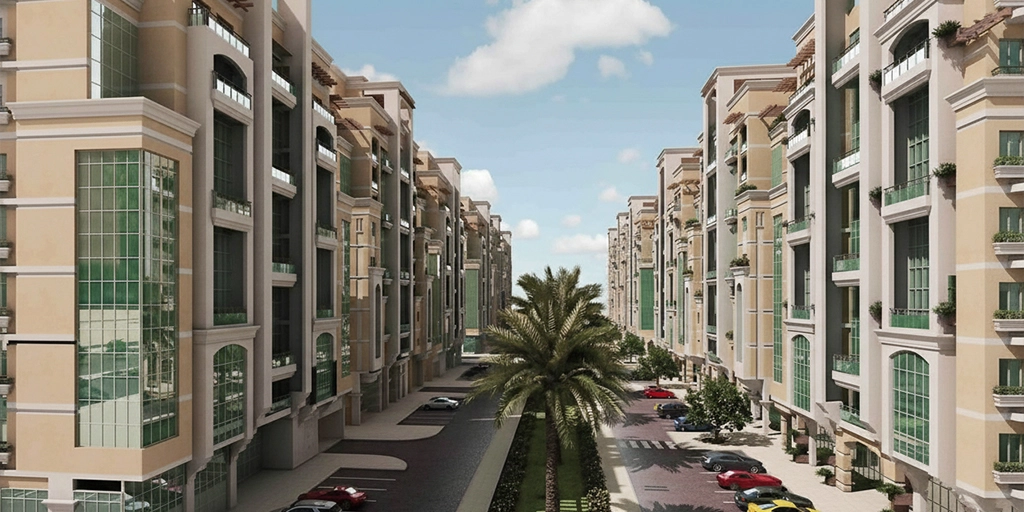 Modern residential buildings with contemporary architecture, palm-lined streets, and parked cars under a clear sky representing upscale urban development and real estate growth in the MENA region.